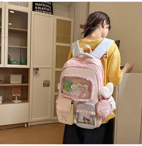 Süßer Dopamin-Farbblock-Schulrucksack mit transparenter Fronttasche und niedlichen Anhängern.