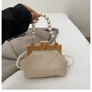 Detailaufnahme einer geflochtenen Handtasche mit Holzverschluss und perlenbesetztem Henkel.