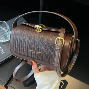 Chic woven cylindrical pillow shoulder bag for women, stylish commuting handbag.