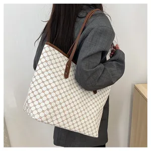 Detail shot of a women's large capacity shoulder tote bag with monogram pattern for daily commuting.