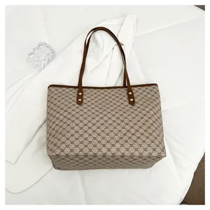 Stylish large capacity tote bag for women, classic monogram pattern with brown handles.