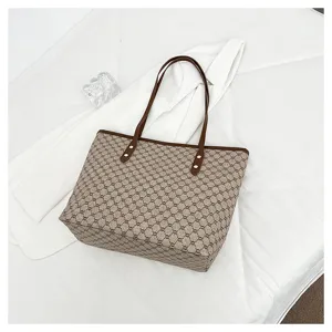 Detailed view of the large capacity tote bag featuring classic monogram pattern and brown trim.
