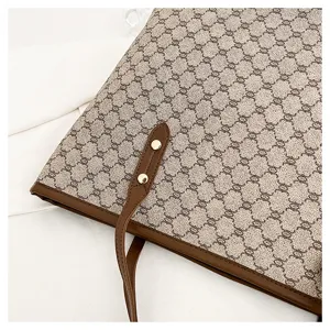 Classic monogram tote bag with brown leather trim, stylish commuter shoulder bag for women detail