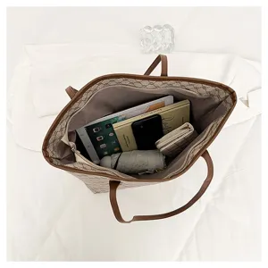 Detailed top-down view of large capacity tote bag interior showing organized daily items.