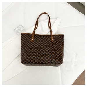 Detailed view of women's retro monogram tote bag, large capacity brown shoulder handbag.