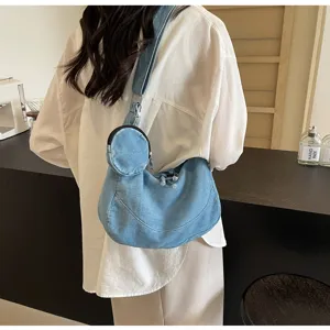Detail shot of a casual light blue denim hobo bag featuring a cute round coin purse and zipper.