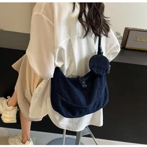 Casual denim dumpling shoulder bag for women, stylish crossbody hobo purse with small round pouch.