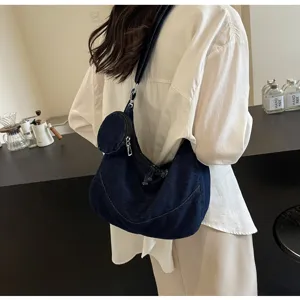 Korean style dark blue denim hobo cross body dumpling bag with mini coin purse accessory.