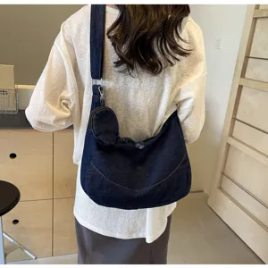 Stylish denim cross-body dumpling bag for women, lightweight and casual daily wear.