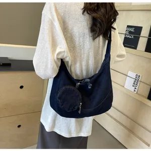 Casual denim crossbody dumpling bag detail, soft shoulder hobo bag with small coin purse.