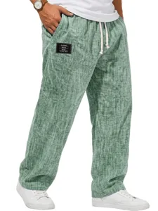 Men green linen casual trousers detail view, showing elastic drawstring waist and black patch.