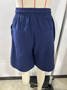 Detail shot of mens casual solid blue cotton linen shorts, showing back pockets and waistband.