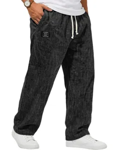 Men's casual linen texture pants detail view with drawstring waist and pocket label.