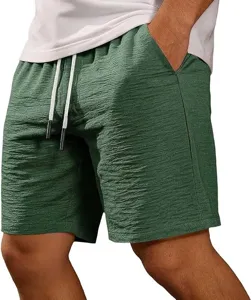 Detail view of textured fabric, elastic drawstring waist, and pockets on mens summer shorts.
