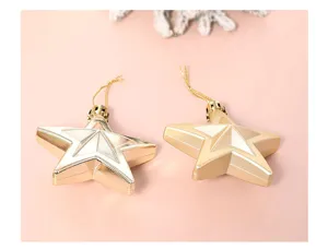Close-up detail of shiny and matte gold star hanging ornaments for holiday decor.
