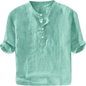Close-up detail of casual men's summer short sleeve linen henley shirt in mint green.