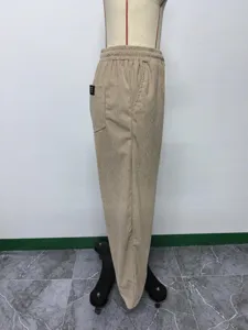 Corduroy straight casual trousers detail showing back pocket badge and soft ribbed texture.