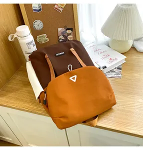 Detail shot of casual color-block backpack featuring large capacity and comfortable straps.