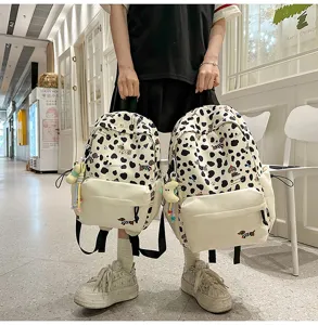Süßer Kuhmuster Rucksack mit Hundemuster, stylische Canvas Schultasche für junge Mädchen.