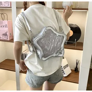 Detailed shot of silver star ita bag worn on back, showing transparent mesh pocket.