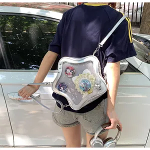 Detailed close-up of star-shaped transparent ita bag worn by model, pin display pocket.