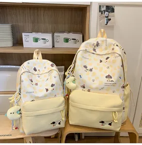Süßer japanischer Canvas-Rucksack mit gelbem Kuhmuster und niedlichen Welpen für Schülerinnen.