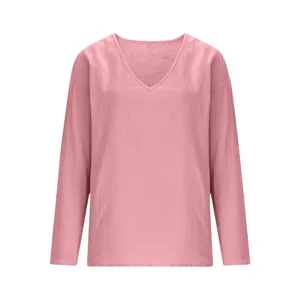 Detail view of the pink long sleeve V-neck casual top fabric texture and relaxed design.