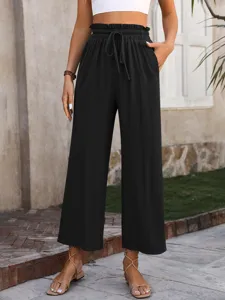 Detailed view of women's black high-waisted wide-leg pants with elastic drawstring waist.