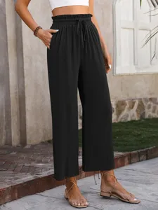 Casual high waist wide leg pants detail showing smocked elastic drawstring waistband and pockets.