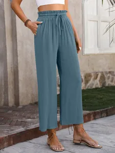 Detail view of casual high waist wide leg trousers in dusty blue with comfortable drawstring.