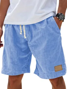 Close-up detail of light blue men's casual shorts featuring adjustable drawstring and leather patch.