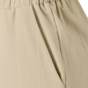 Close-up detail of women's casual trousers side pocket and elastic waistband texture.