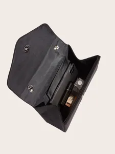 Detailed view of black velvet envelope evening clutch interior with phone and cosmetics storage.