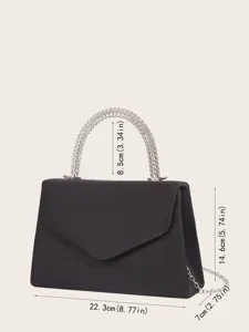 Elegant black velvet evening bag with rhinestone handle and chain strap detail shot.