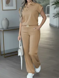 Detail view of the solid color short-sleeve polo top and stylish draped straight pants set.