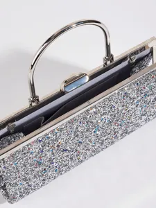 Nahaufnahme einer silbernen Glitzer Abendtasche mit Metallrahmen und Griff Innendetails.