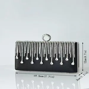 Detail view of black rhinestone evening clutch bag with sparkling crystal tassels and lock.