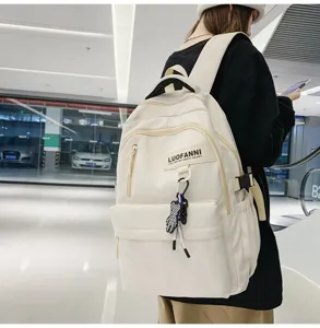 Vue détaillée du grand sac à dos en toile beige avec de multiples poches pratiques.