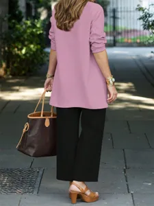 Chic long sleeve top matched with straight pants and elegant tote bag detail shot.