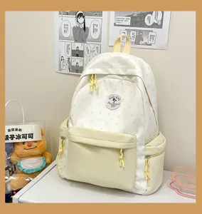 Detailansicht des niedlichen cremefarbenen Rucksacks mit Sternenmuster und praktischen Taschen.