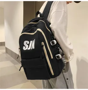 Detail view of the trendy black backpack with bold white lettering and spacious compartments.