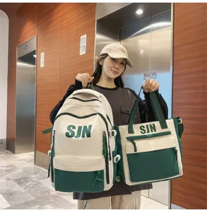 Two-piece school backpack and tote set in beige and green, featuring letter print design.
