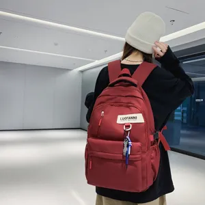 Sac à dos d'école rouge en toile de grande capacité pour étudiants, style quotidien.