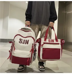 Detail view of a trendy two-piece colorblock canvas school backpack and matching tote bag.