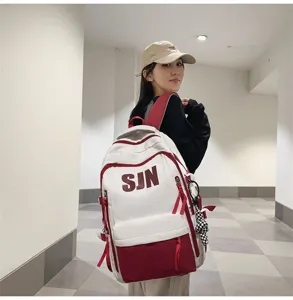 Detailed view of the stylish contrast color school backpack worn by model, showcasing daily use.