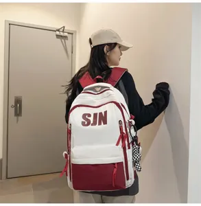 Large capacity student backpack white red color block casual school bag for daily commute.