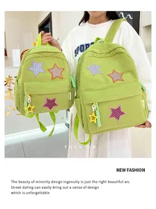 Corduroy backpack detail showing cute star patches, green fabric, and decorative pendant.