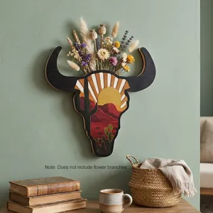 Detailed shot of the wooden bull skull wall hanging with rustic desert sunset cactus design.
