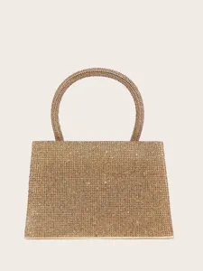 Glänzende Strass Abendtasche Detail, elegante goldene Party Handtasche mit rundem Griff Nahaufnahme.