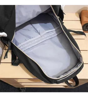 Backpack interior detail showing spacious compartment, multi-layer pocket and grey lining.